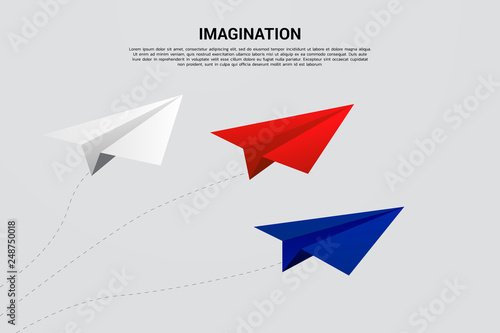 red blue and white origami paper airplane flying. concept of idea and imagination
