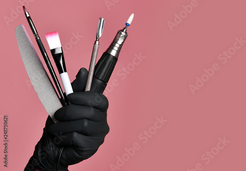 Obraz na płótnie Hand hold pedicure equipment for manicure instruments for nails salon and spa brush nail file with abrasive w salonie