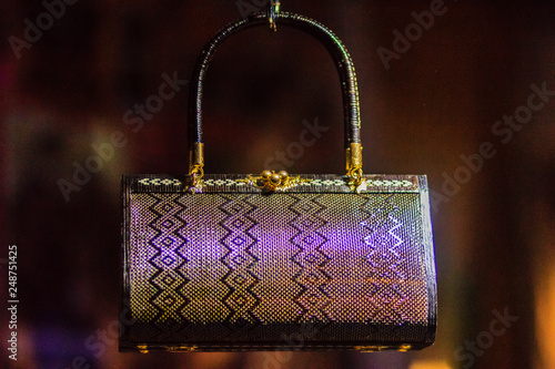 Beautiful lady handbags and basketry that made from Lygodium (climbing fern), or "Yan lipao" in Thai, the famous product from Southern Thailand for sale at night market, Bangkok. Night shot with grain