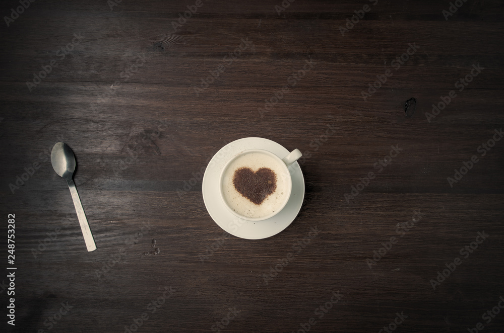 Coffee cup with heart shape cinnamon on wood background. Valentine's concept Coffee cup with heart shape cinnamon on wood background. Valentine's concept
