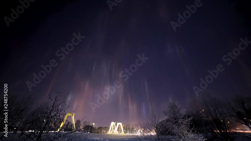 Artificial light pillars over the city of  J√§rvenp√§√§ in Finland, filmed as a timelapse in 4k. photo