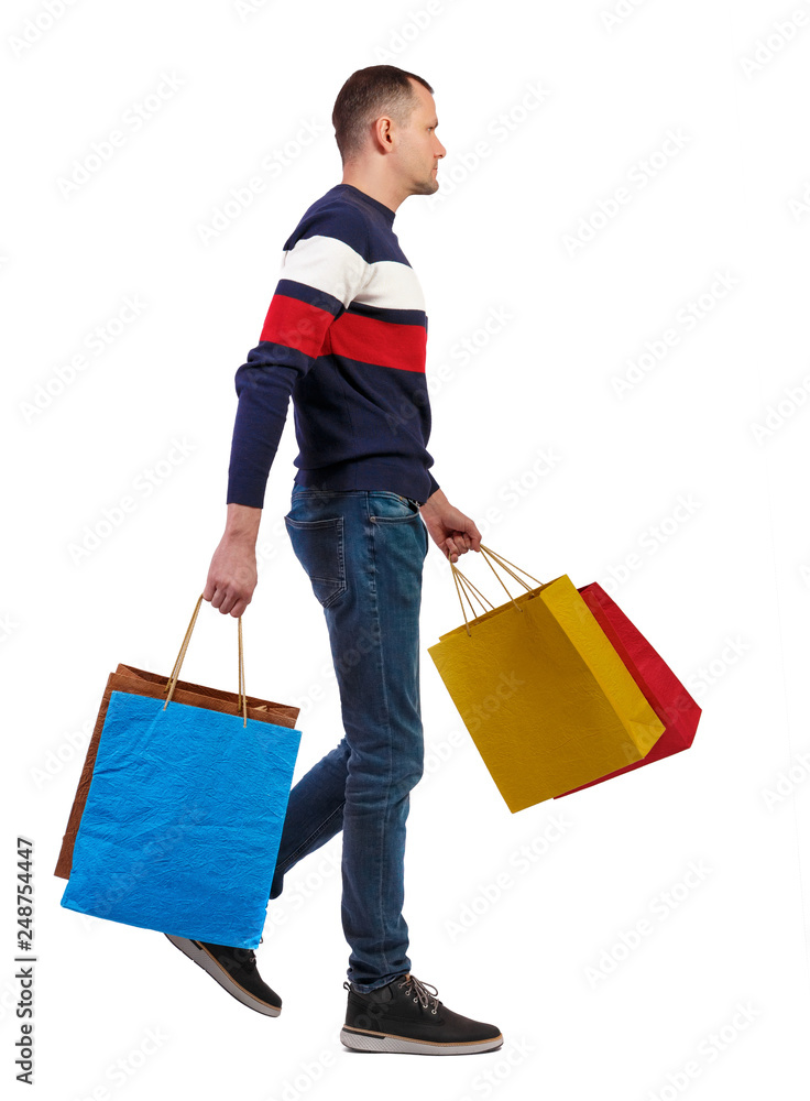 Side view of going man with shopping bags. Side view of going man with shopping bags.