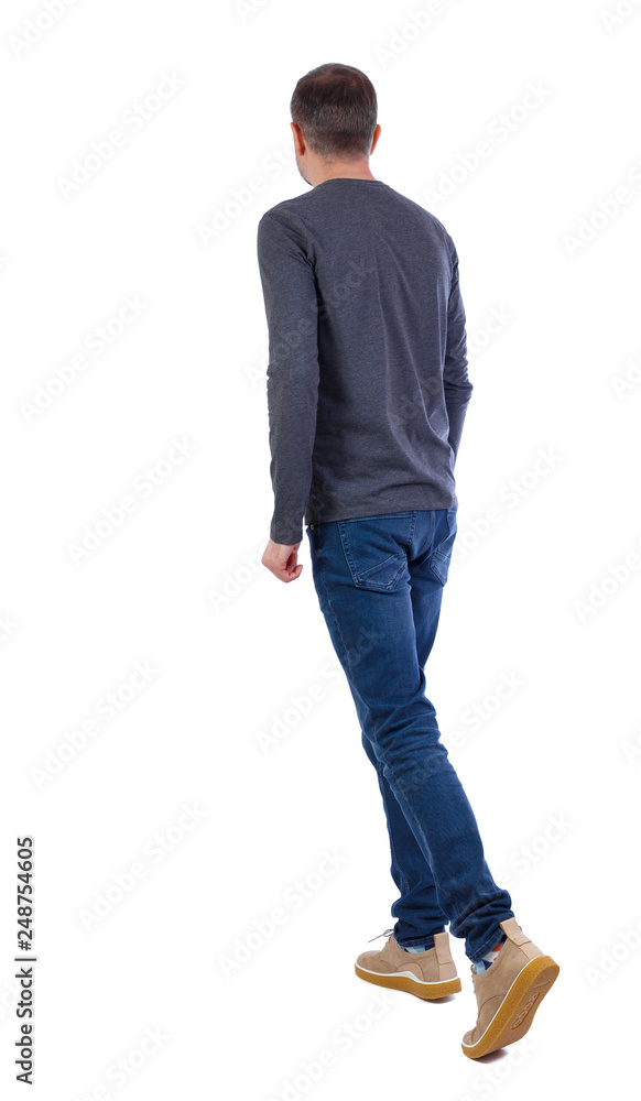 Naklejka premium Back view of going handsome man .