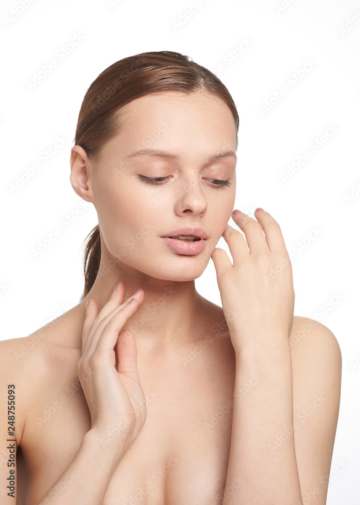 Beauty portrait of young girl with brown hair and big lips on white background with clean face skin and arm near head. Good for cosmetic, medicine and spa . European type Beauty portrait of young girl with brown hair and big lips on white background with clean face skin and arm near head. Good for cosmetic, medicine and spa . European type