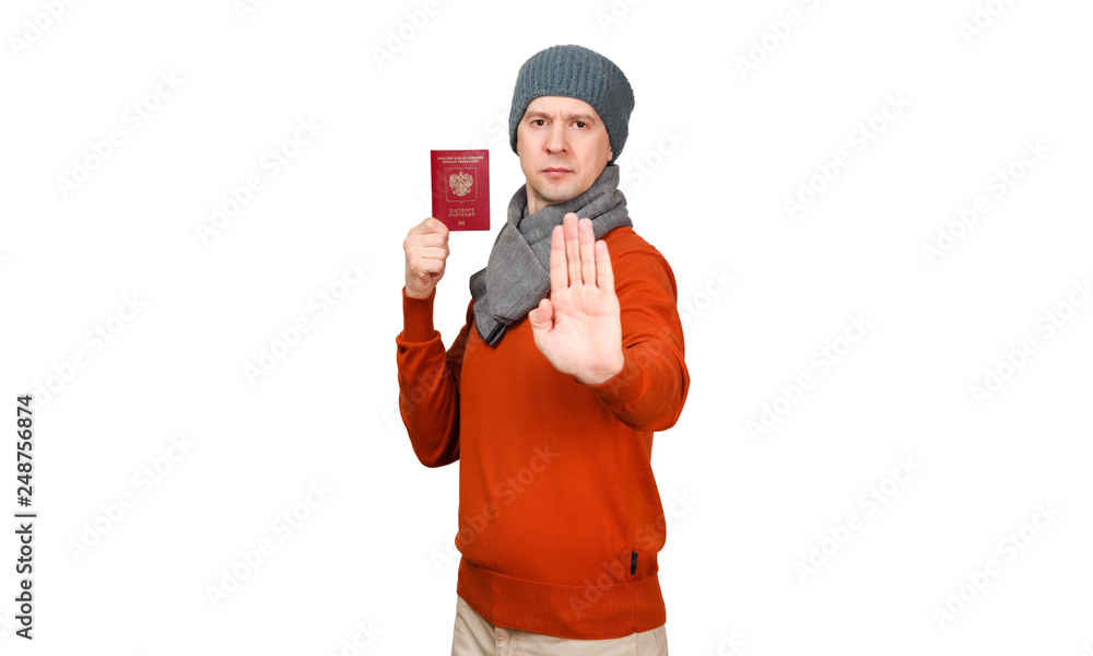 The Caucasian man with the international passport of the Russian Federation in warm clothes. Holds the opened palm before itself, the gesture - an appeal will stop The Caucasian man with the international passport of the Russian Federation in warm clothes. Holds the opened palm before itself, the gesture - an appeal will stop