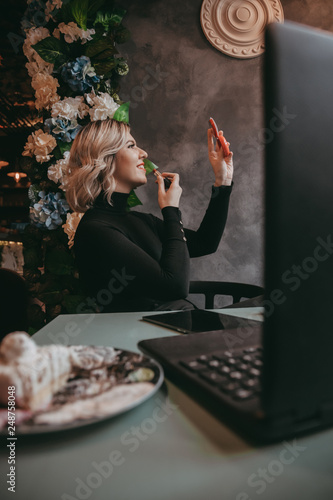 Girl typing on laptop and drinking coffee