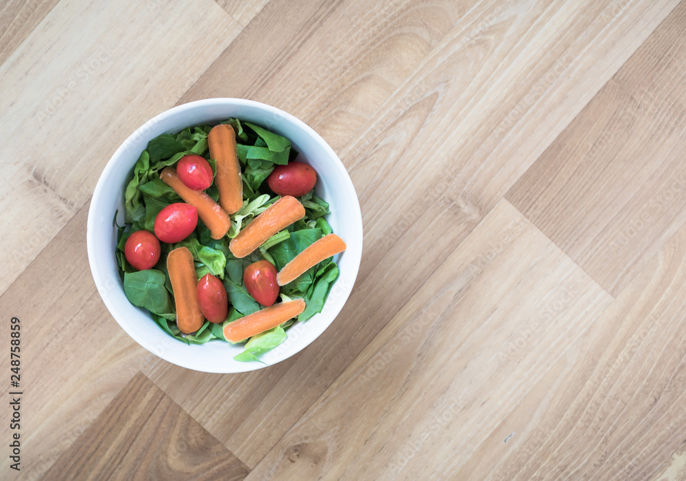bowl of salad on table bowl of salad on table