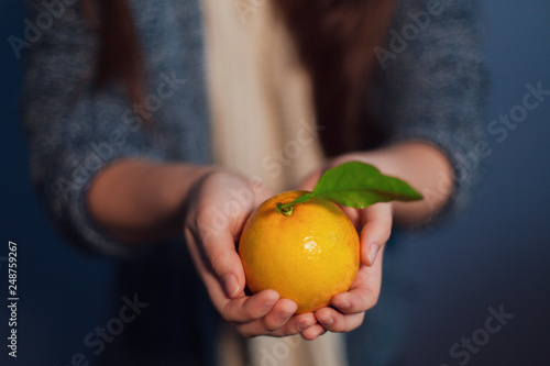 woman holding an orange