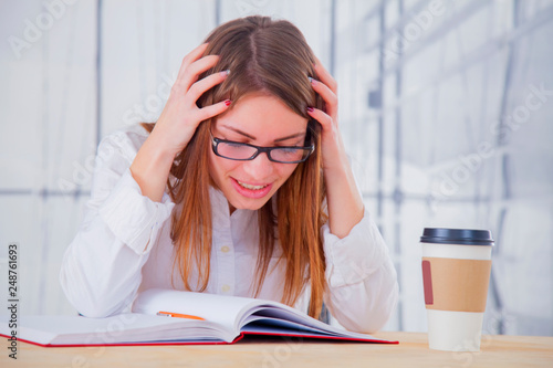 Portrait of depressed young business woman working overtime with low wages and without career perspective.