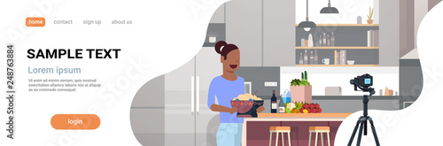 girl food blogger recording video on camera african american woman preparing tasty dish modern kitchen interior cooking blog concept female character portrait flat copy space horizontal