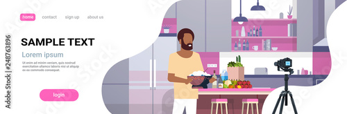 guy food blogger recording video on camera african american man preparing tasty dish modern kitchen interior cooking blog concept male character portrait flat copy space horizontal