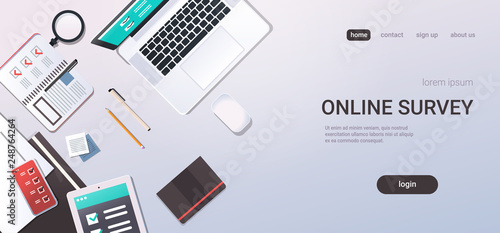 workplace desk online testing questionnaire form survey concept internet quiz laptop computer top angle view office stuff flat copy space horizontal