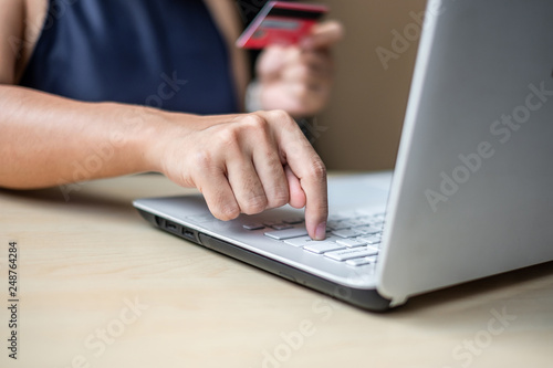 Businesswoman holding credit card  for online shopping while making orders via the Internet. business, technology, ecommerce and online payment concept