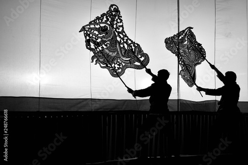 A group of people are playing an old Thai traditional shadow play called as Nang Yai,Composed to Black and White.
