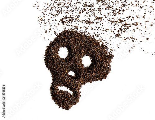 Skull shape made from dried tea leaves isolated on white background.