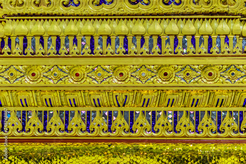 Beautiful golden base of the movable throne in Thai's style patterns for contain the Lord Buddha relics enshrined. Located at the departure floor of Suvarnabhumi airport, Bangkok, Thailand.