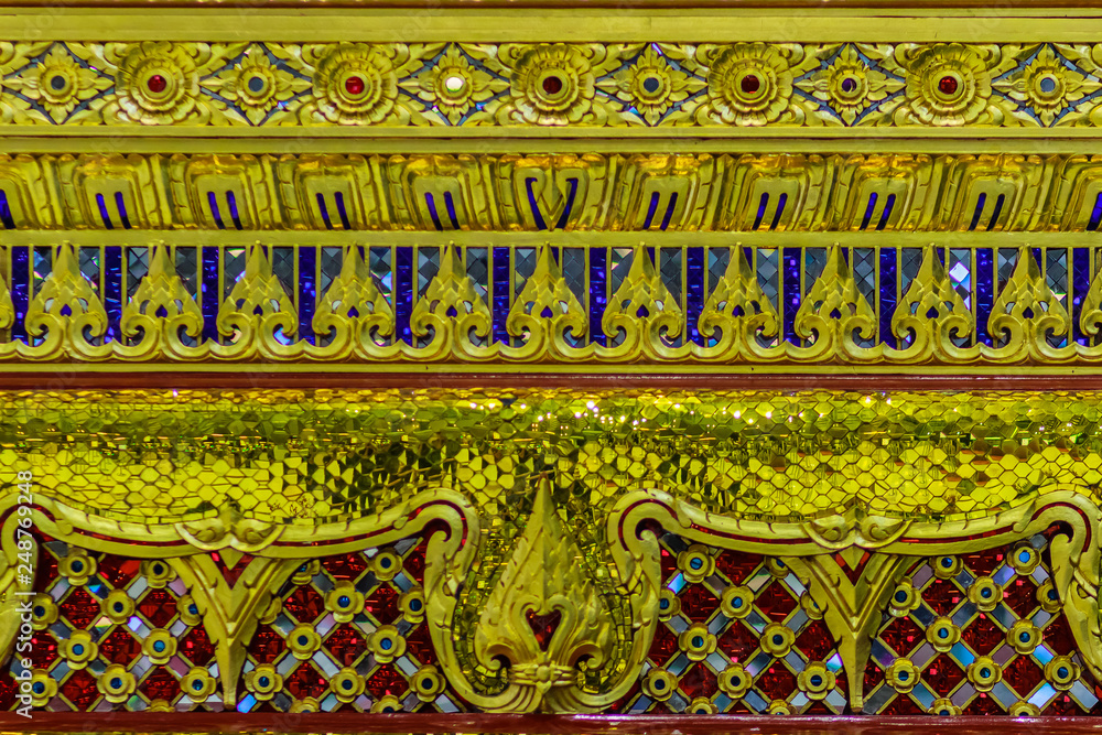 Beautiful golden base of the movable throne in Thai's style patterns for contain the Lord Buddha relics enshrined. Located at the departure floor of Suvarnabhumi airport, Bangkok, Thailand. Beautiful golden base of the movable throne in Thai's style patterns for contain the Lord Buddha relics enshrined. Located at the departure floor of Suvarnabhumi airport, Bangkok, Thailand.