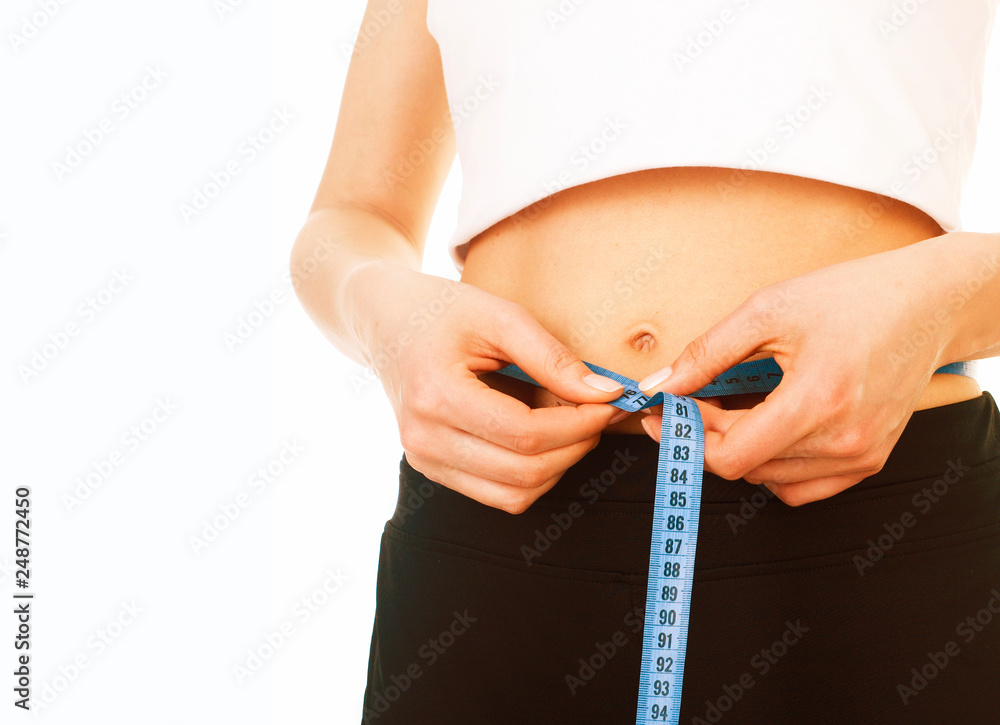 Fototapeta premium young girl measuring herself