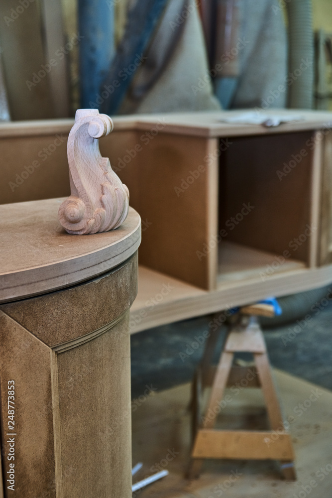 Carved leg. Classic desktop. Building tabletop. Wooden furniture manufacturing process Carved leg. Classic desktop. Building tabletop. Wooden furniture manufacturing process