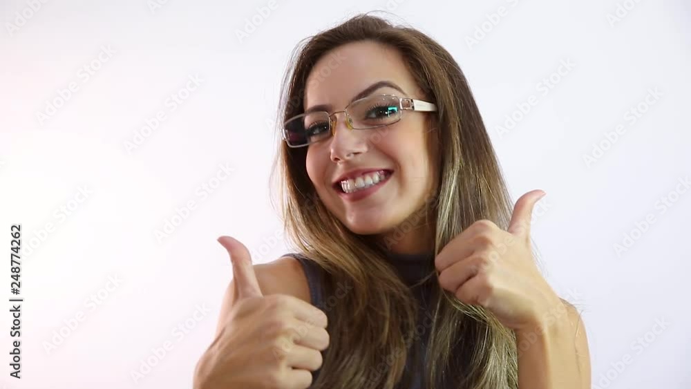 Beautiful young girl in eyeglasses is looking at camera and smiling, on white background Beautiful young girl in eyeglasses is looking at camera and smiling, on white background