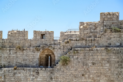 Ancient wall with arrowslit in the Old City of Jerusalem photo