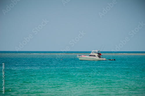 Landscape of speed boat in Naiyang Beach with blue sky background at Phuket, Thailand