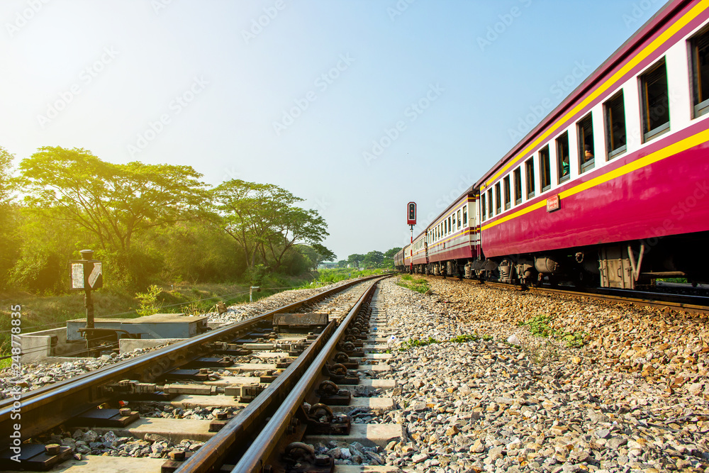 Procession bogey compartment train at curve and sail through rail chopper with traffic light before entering Ratchaburi station of Thailand. Procession bogey compartment train at curve and sail through rail chopper with traffic light before entering Ratchaburi station of Thailand.