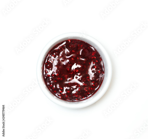Bowl with red jam on white background