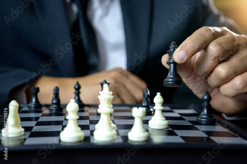 Businessman play chess how to crash overthrow the competitor