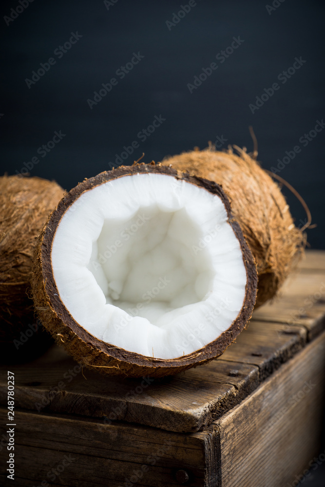 Fresh coconuts on the rustic background. Selective focus. Shallow depth of field. Fresh coconuts on the rustic background. Selective focus. Shallow depth of field.