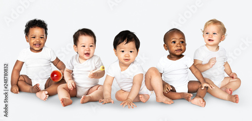 Diverse babies sitting on the floor photo