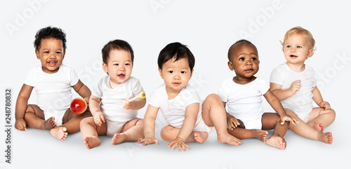 Vászonkép Diverse babies sitting on the floor