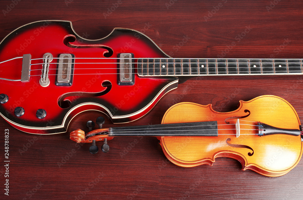 Violin and bass guitar on the table Violin and bass guitar on the table