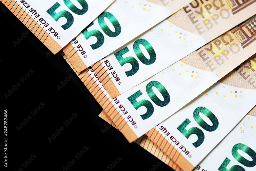 Fifty euro banknotes on a dark background close up Fifty euro banknotes on a dark background close up