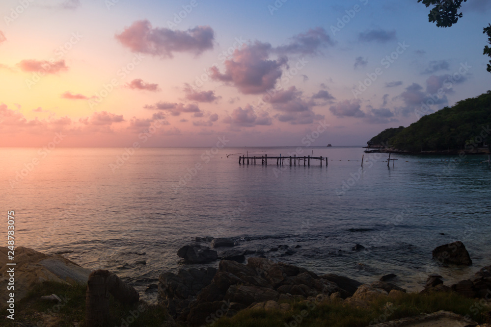 Sunset view of Wooen jetty was abandoned. Located by the beach Stretching into the sea.