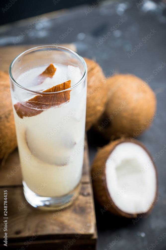 Sweet coconut cocktail on the wooden background. Selective focus. Shallow depth of field. Sweet coconut cocktail on the wooden background. Selective focus. Shallow depth of field.