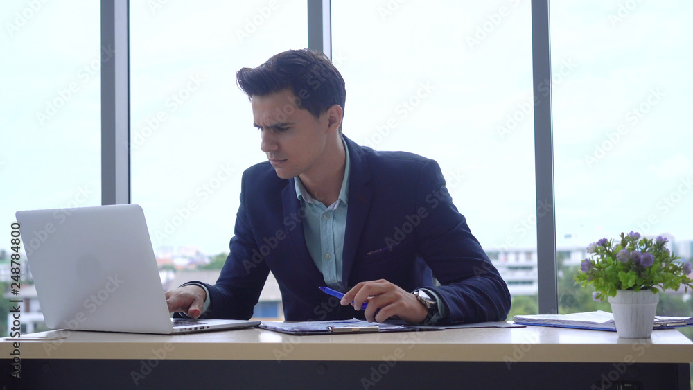 Businessmen are working in the computer-ready office and recording data into the clipboard. Businessmen are working in the computer-ready office and recording data into the clipboard.