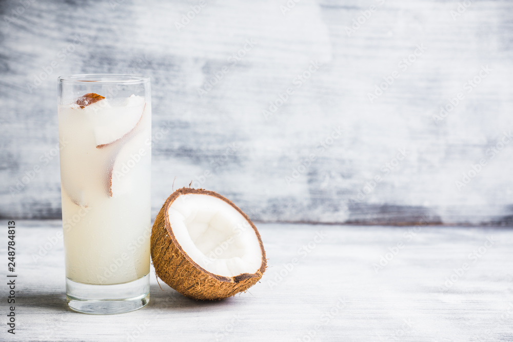 Sweet coconut cocktail on the wooden background. Selective focus. Shallow depth of field. Sweet coconut cocktail on the wooden background. Selective focus. Shallow depth of field.