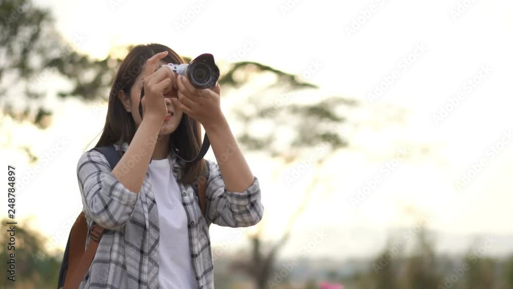 tourist woman taking a photo with her camera in nature tourist woman taking a photo with her camera in nature