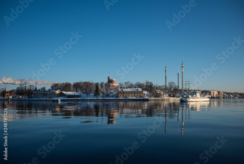 A cold winter  day in Stockholm with snow and ice on islands and boats