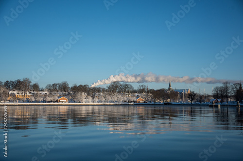 A cold winter day in Stockholm with snow and ice on islands and boats