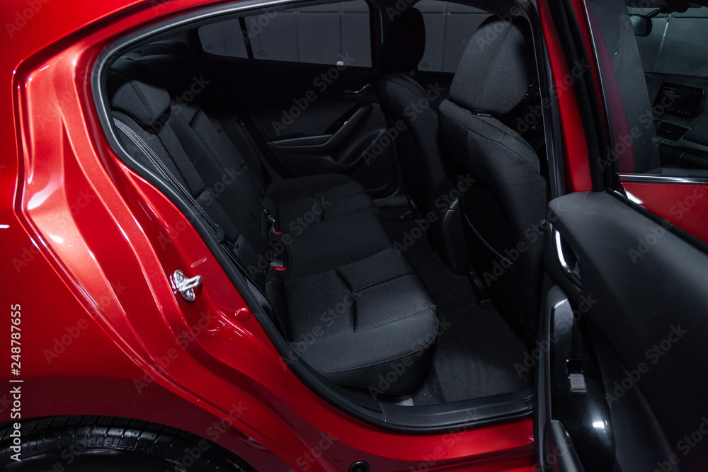 Сlose-up of the car  black interior:  black  rear seats and seat belts .