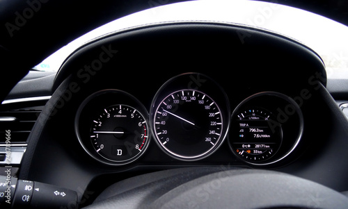 Glowing dashboard showing engine revolutions and speed inside a car 