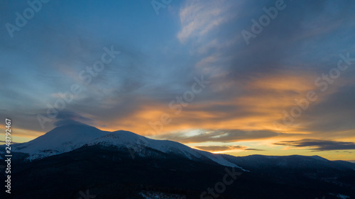Beautiful winter sunrise in the mountains, shot from the air. © slava2271