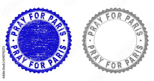 Grunge PRAY FOR PARIS stamp seals isolated on a white background. Rosette seals with grunge texture in blue and grey colors. Vector rubber stamp imitation of PRAY FOR PARIS title inside round rosette.