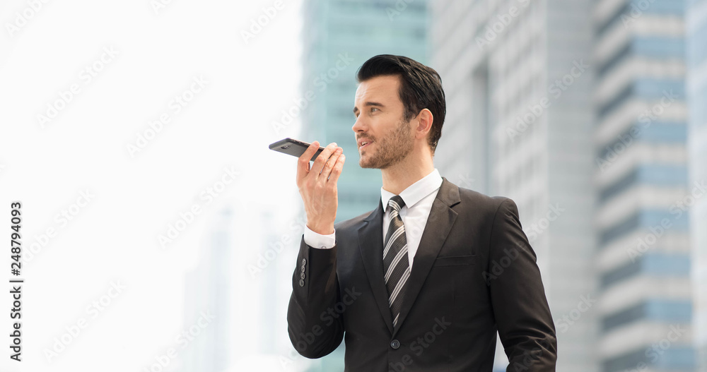 Attractive business man in suit using smart phone internet conferences, translated. Celebrated, Success people of the organization. The winner people customer service evaluation teamwork. Attractive business man in suit using smart phone internet conferences, translated. Celebrated, Success people of the organization. The winner people customer service evaluation teamwork.
