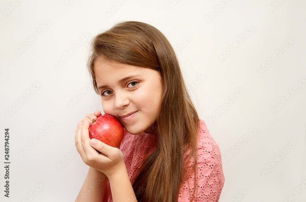 girl on a light background with a red Apple in her hands girl on a light background with a red Apple in her hands