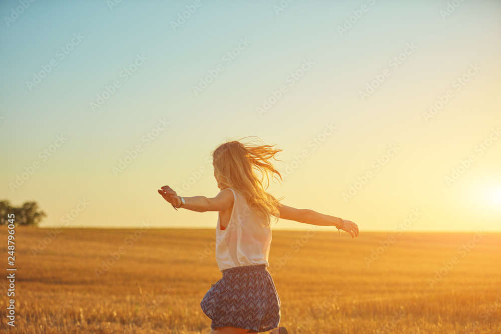 Cute young woman jumping in a wheat field. Cute young woman jumping in a wheat field.