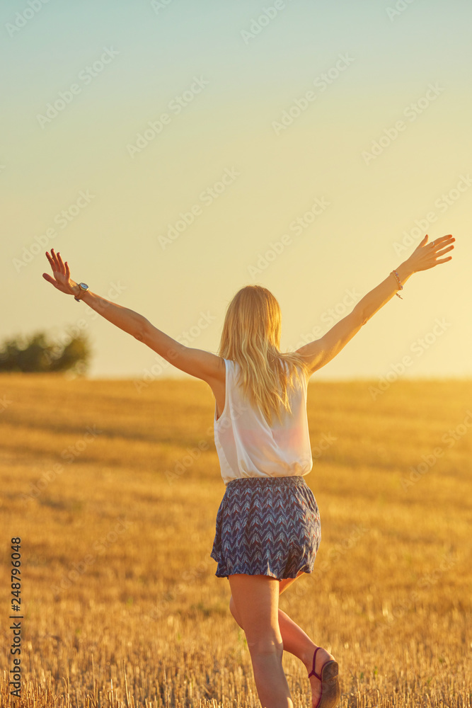 Cute young woman jumping in a wheat field. Cute young woman jumping in a wheat field.