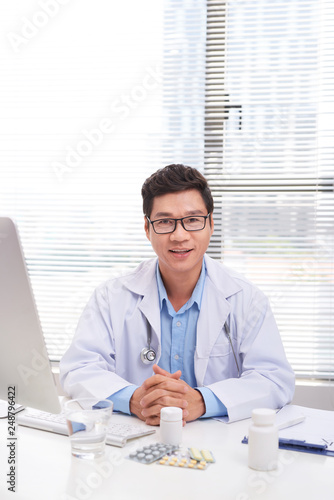 Portrait of senior doctor sitting in medical office